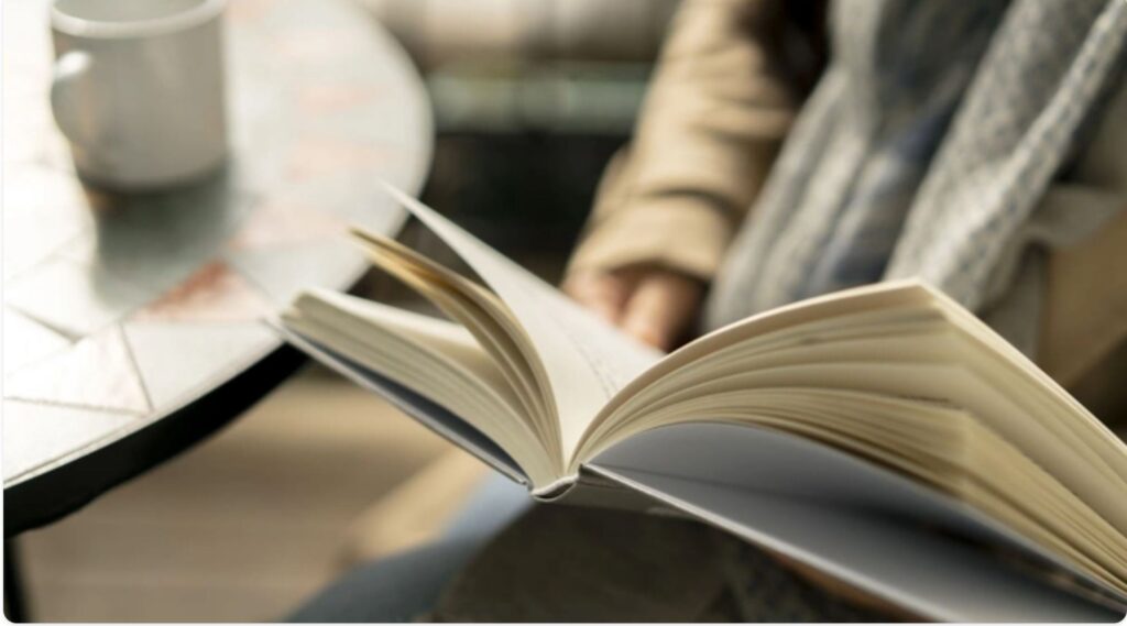 Business owner reading and taking notes as part of a continuous learning routine