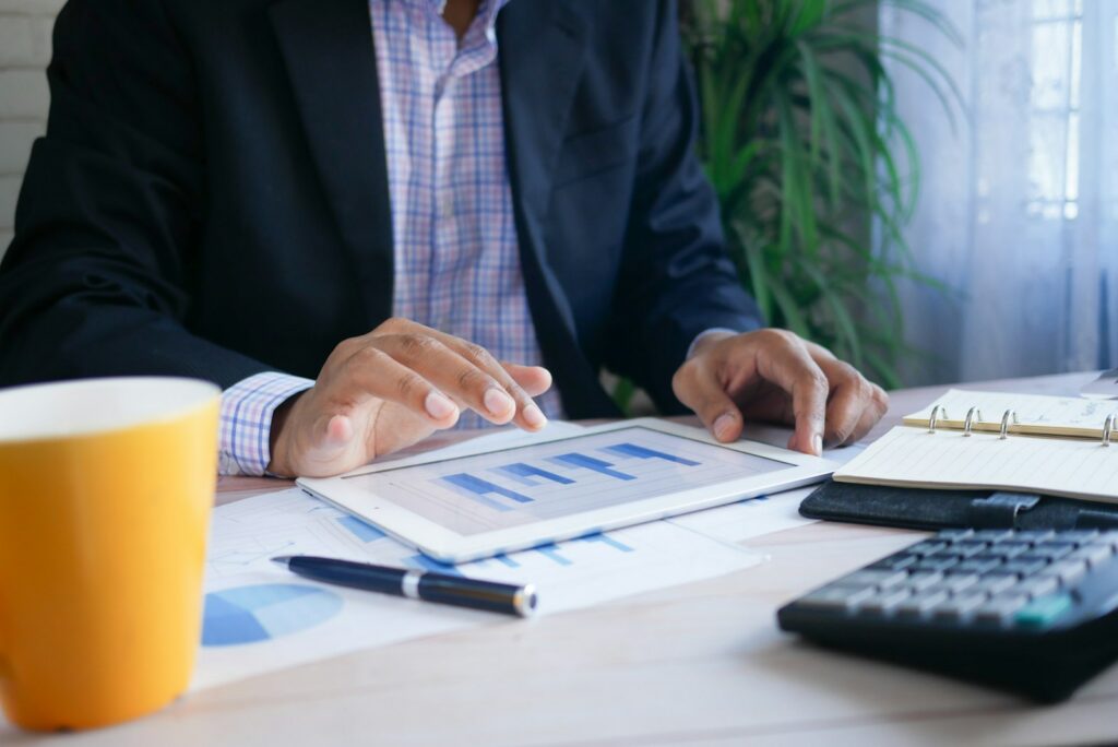 Business owner reviewing a one-page balanced scorecard example on a laptop