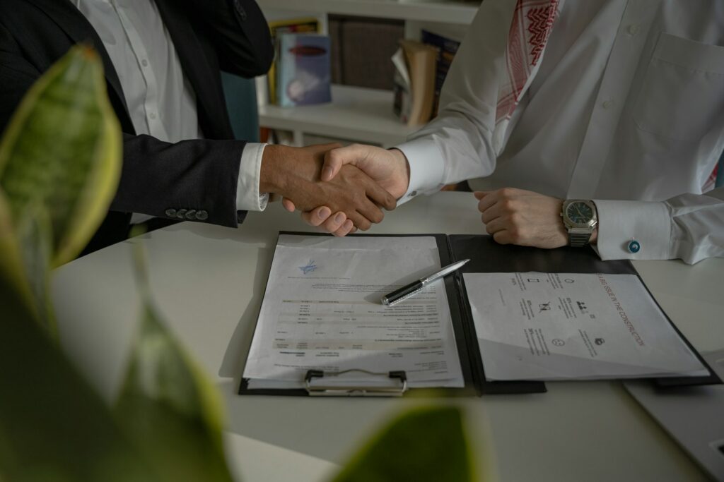 Handshake over a signed agreement after a business loan in South Africa is approved