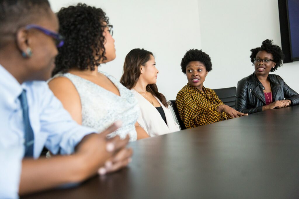 Manager and team discussing employee engagement strategies in a small business office