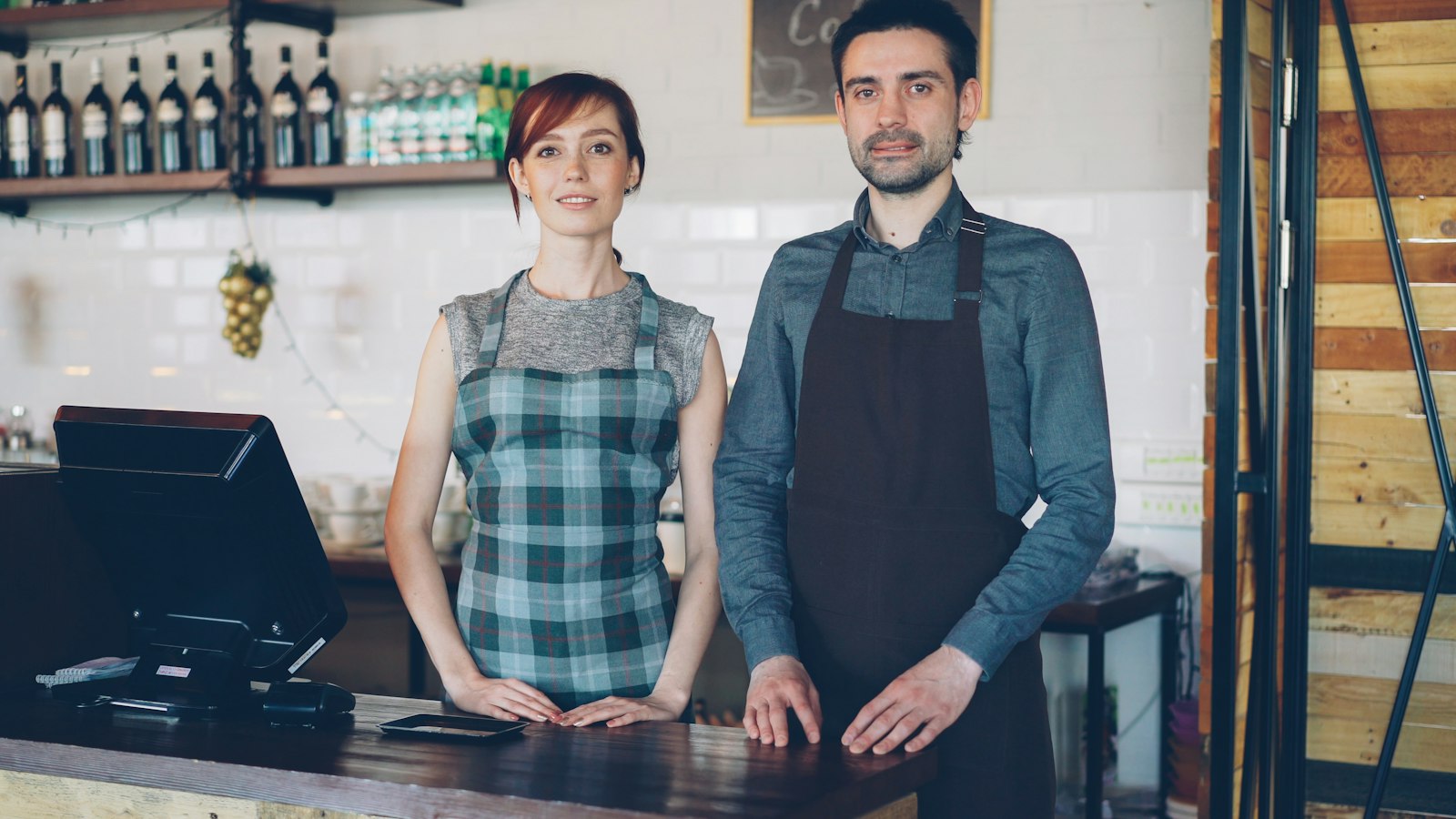 Small business owners in-store discussing their pricing strategy for small business growth