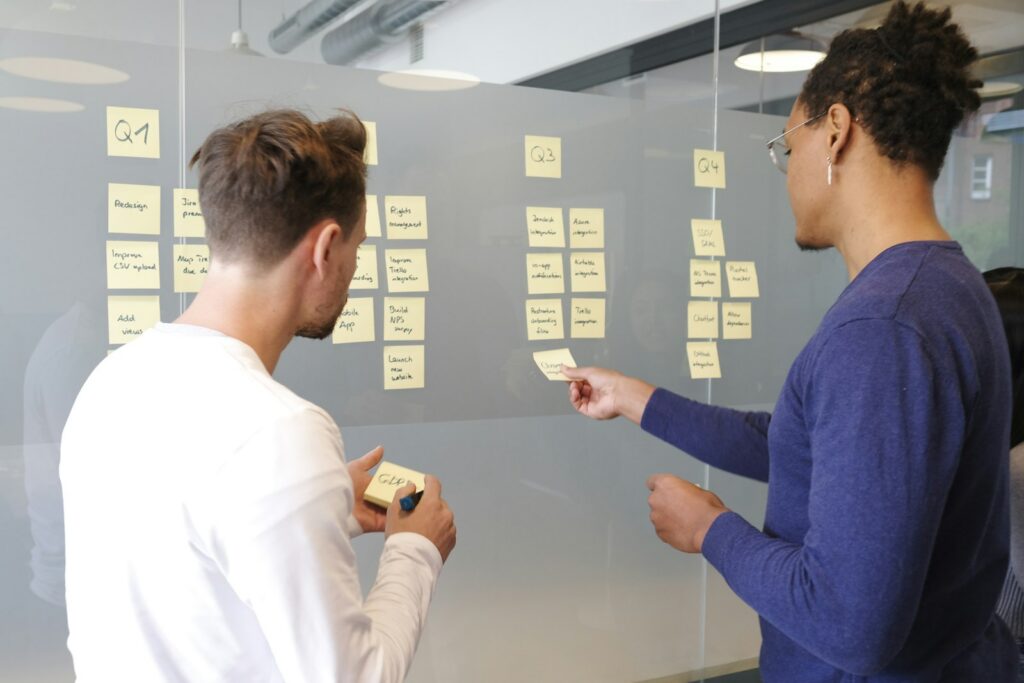 Managers mapping responsibilities on a whiteboard to build a RACI chart for their business